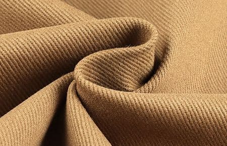 Khaki cotton twill fabric in a swirl